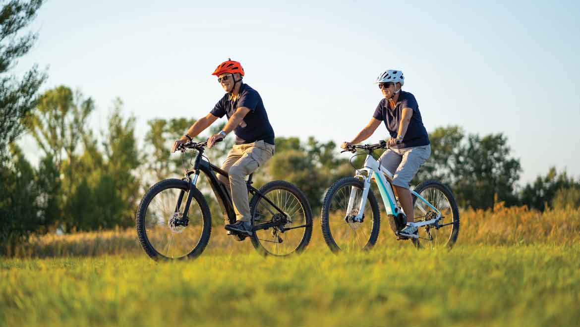 People riding e-bikes