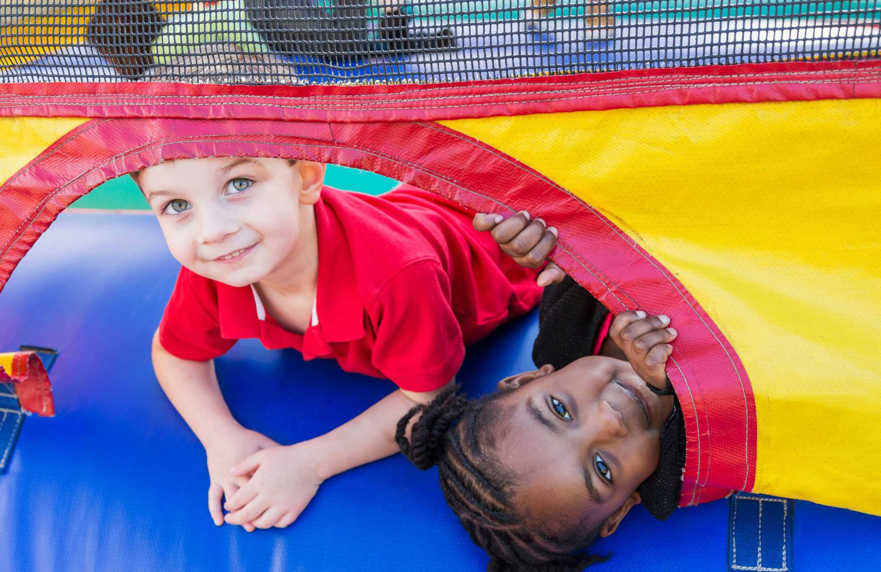 Kids playing in a bounce house.