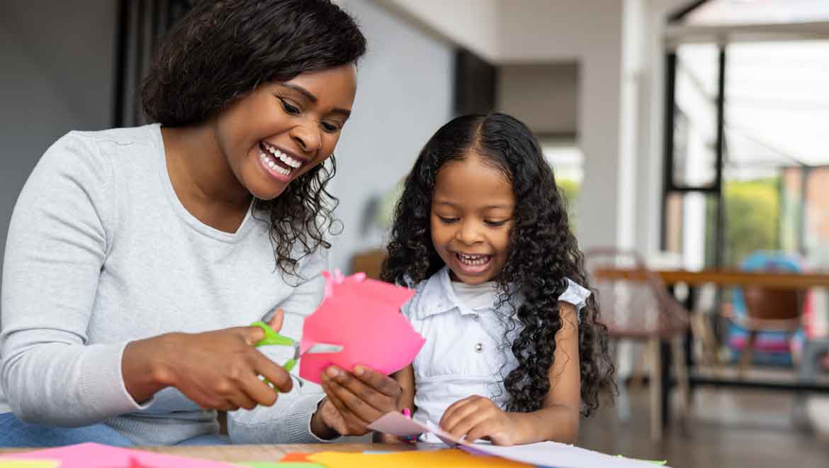 Mother and child cutting paper