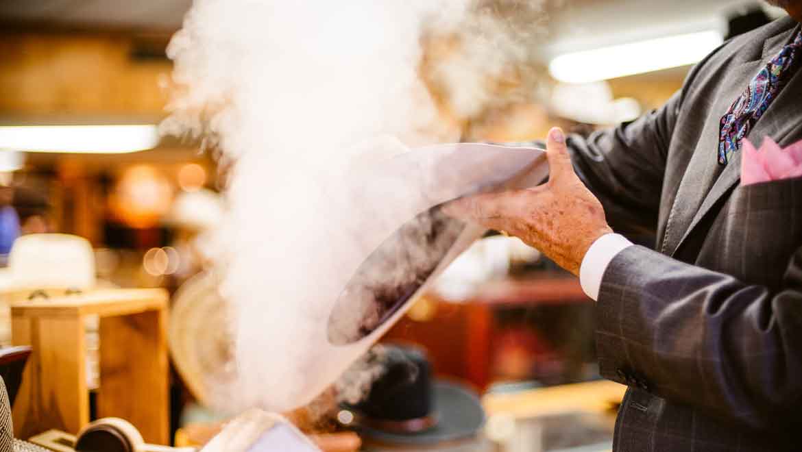 Man steaming a cowboy hat
