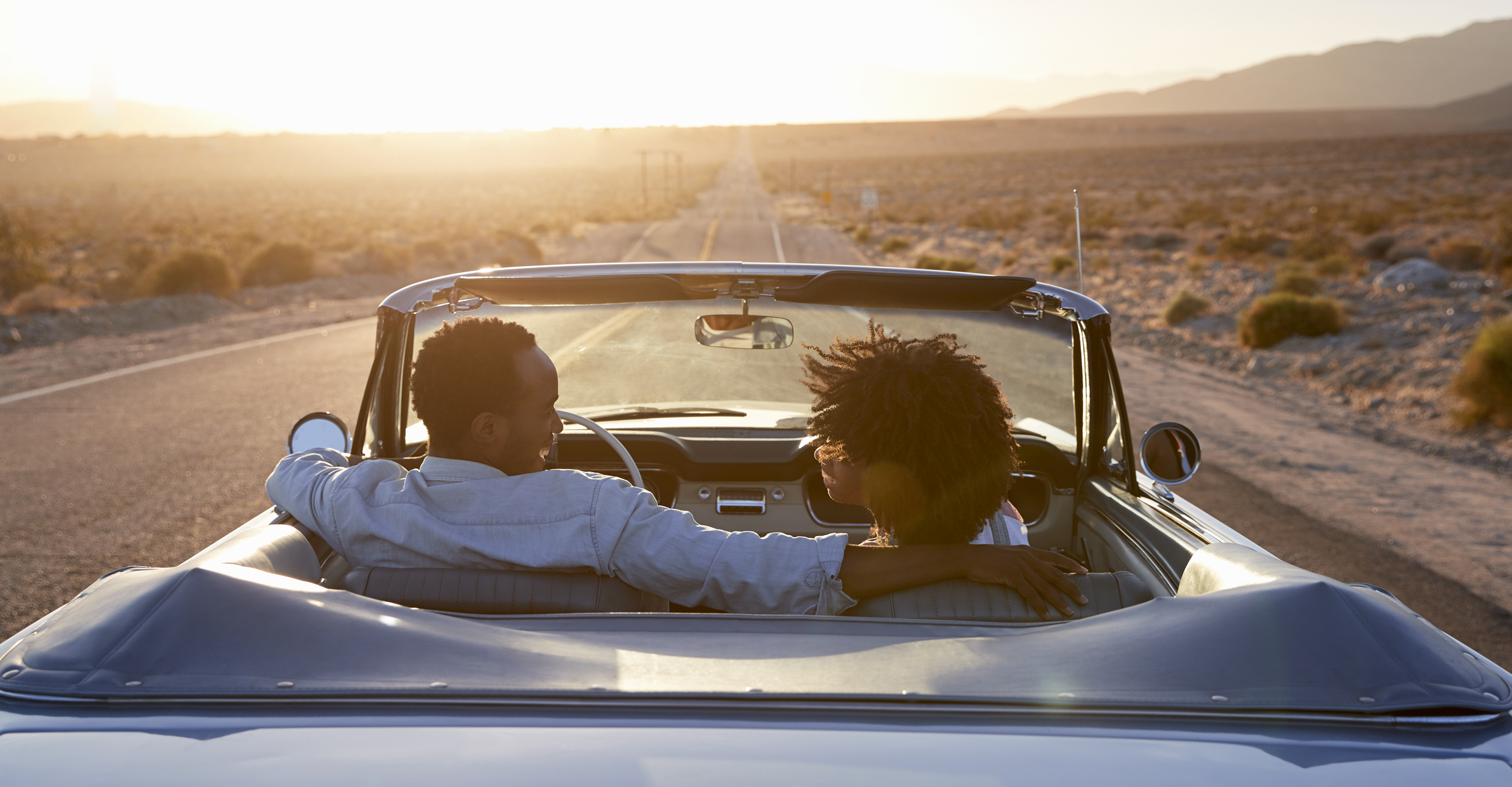 People riding in a convertible car