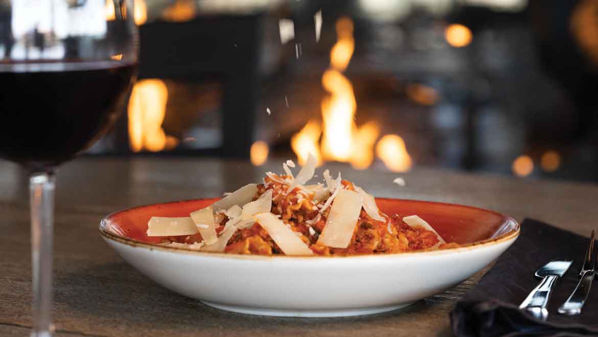 Pasta dish and glass of red wine.