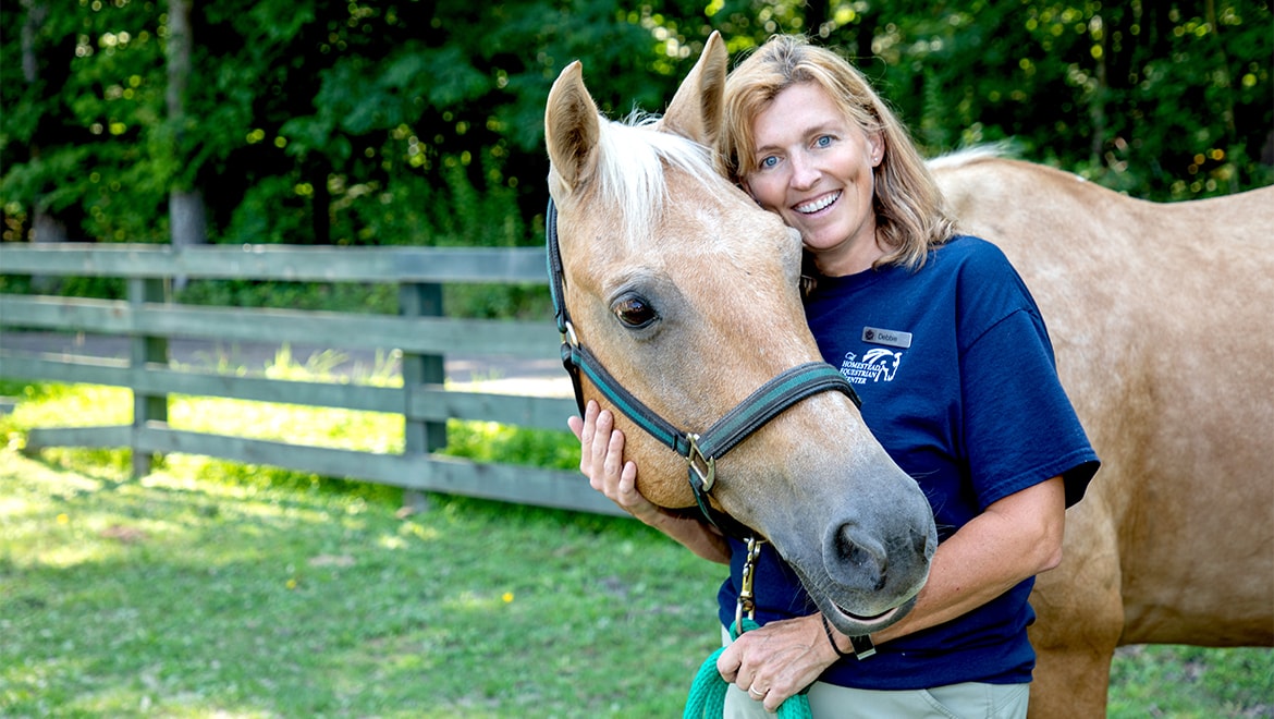 Woman posing with horse