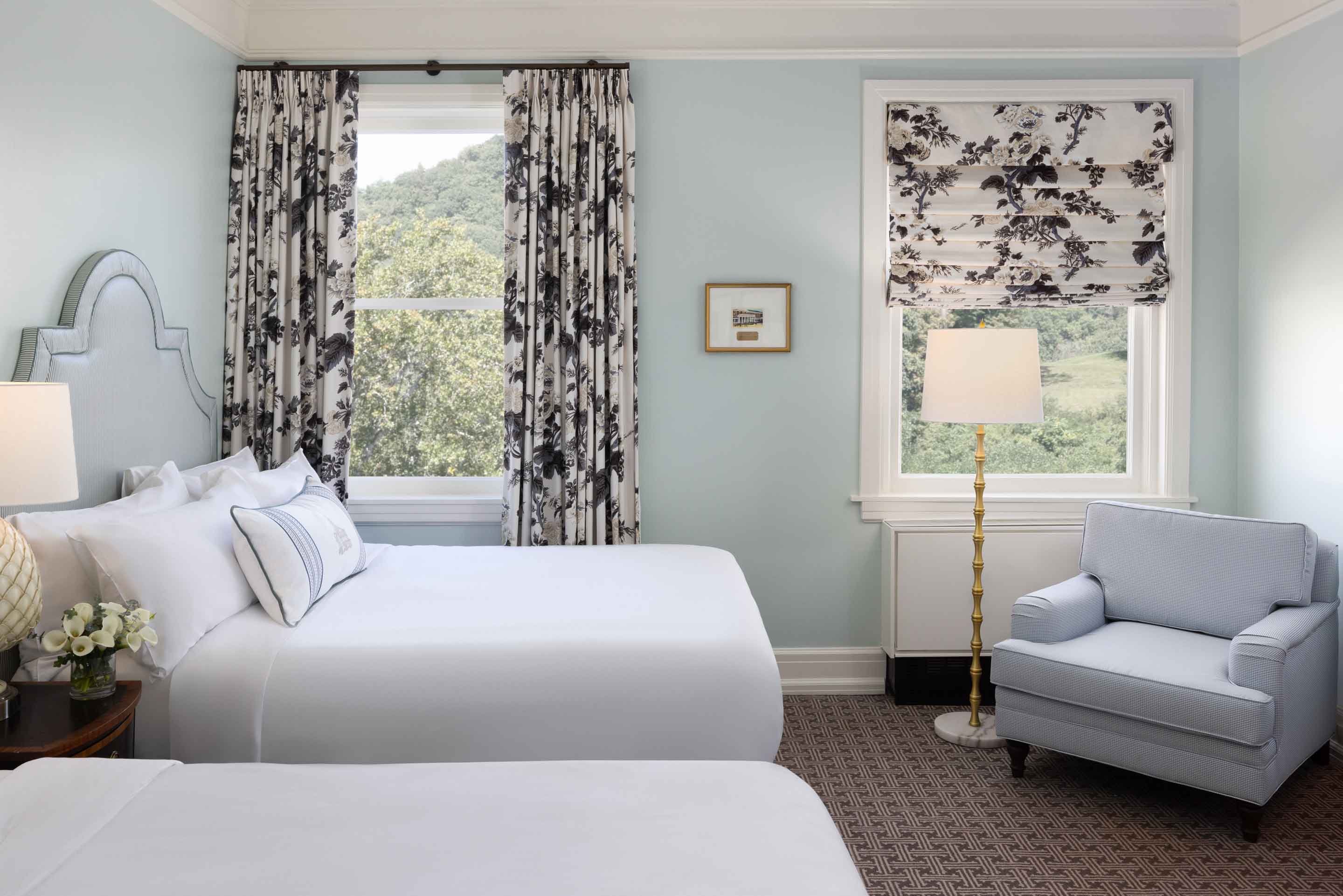 Queen room with sitting chair.