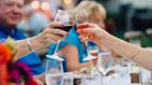 guests clink their wine glasses at an event at the Omni Homestead Resort