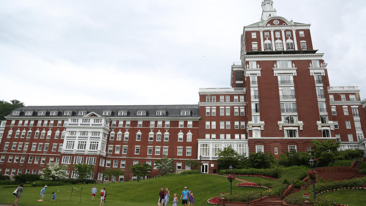 people on the lawn outside Omni Homestead Resort