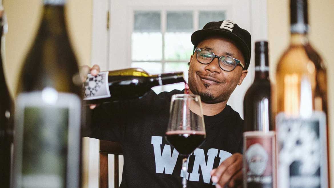 Reggie pouring wine.