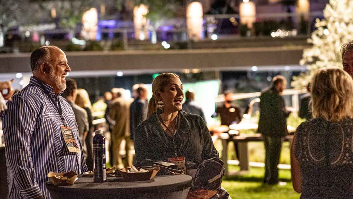 People at cocktail round visitng.