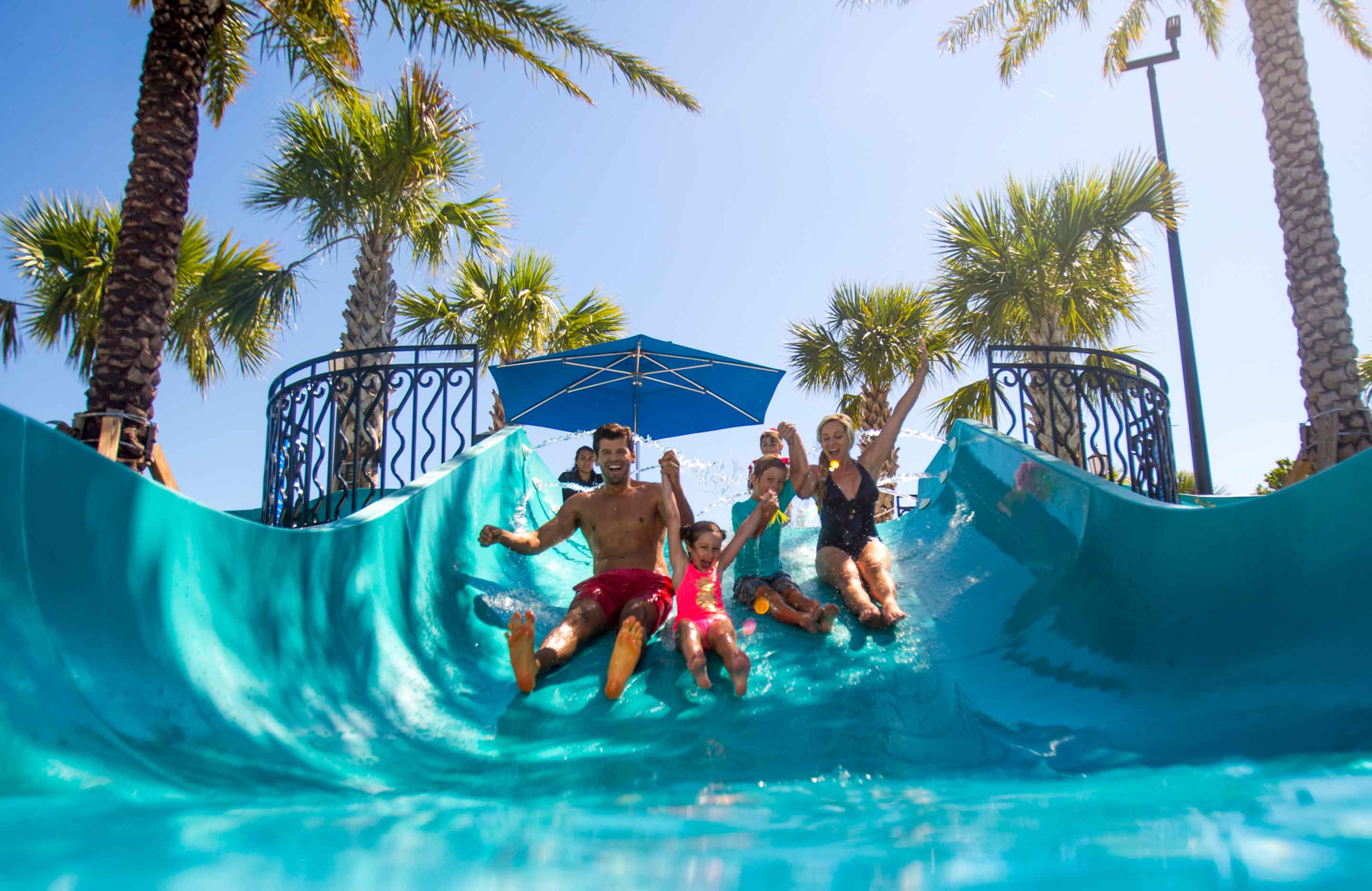 Family riding the waterslide together.
