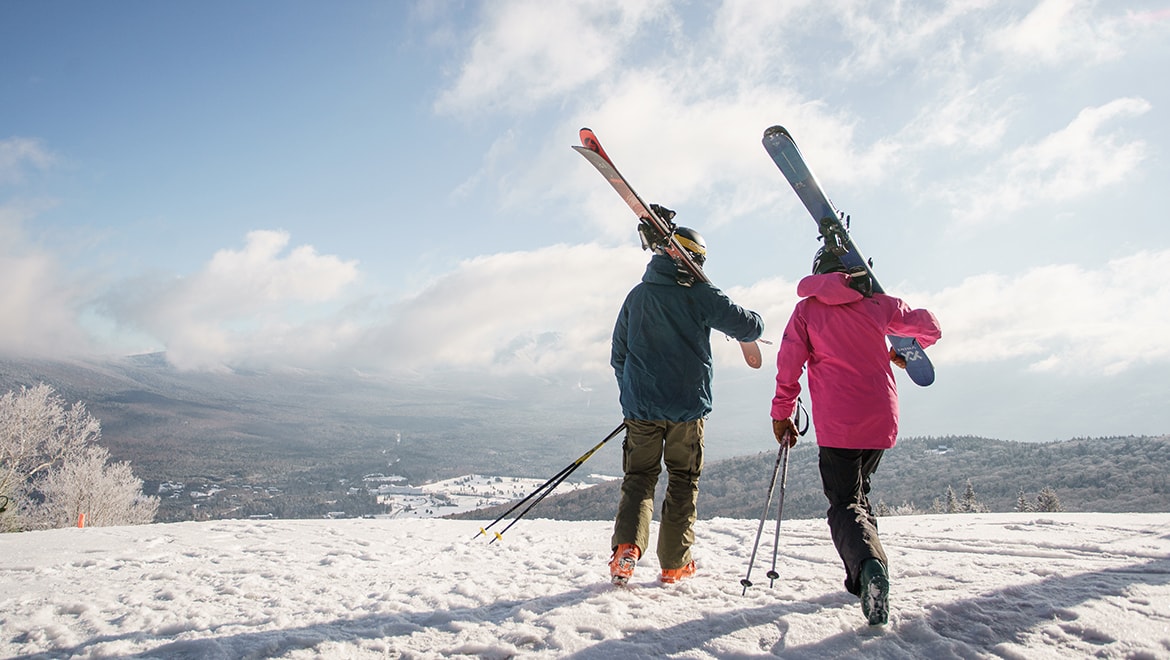 Skiers walking with skis