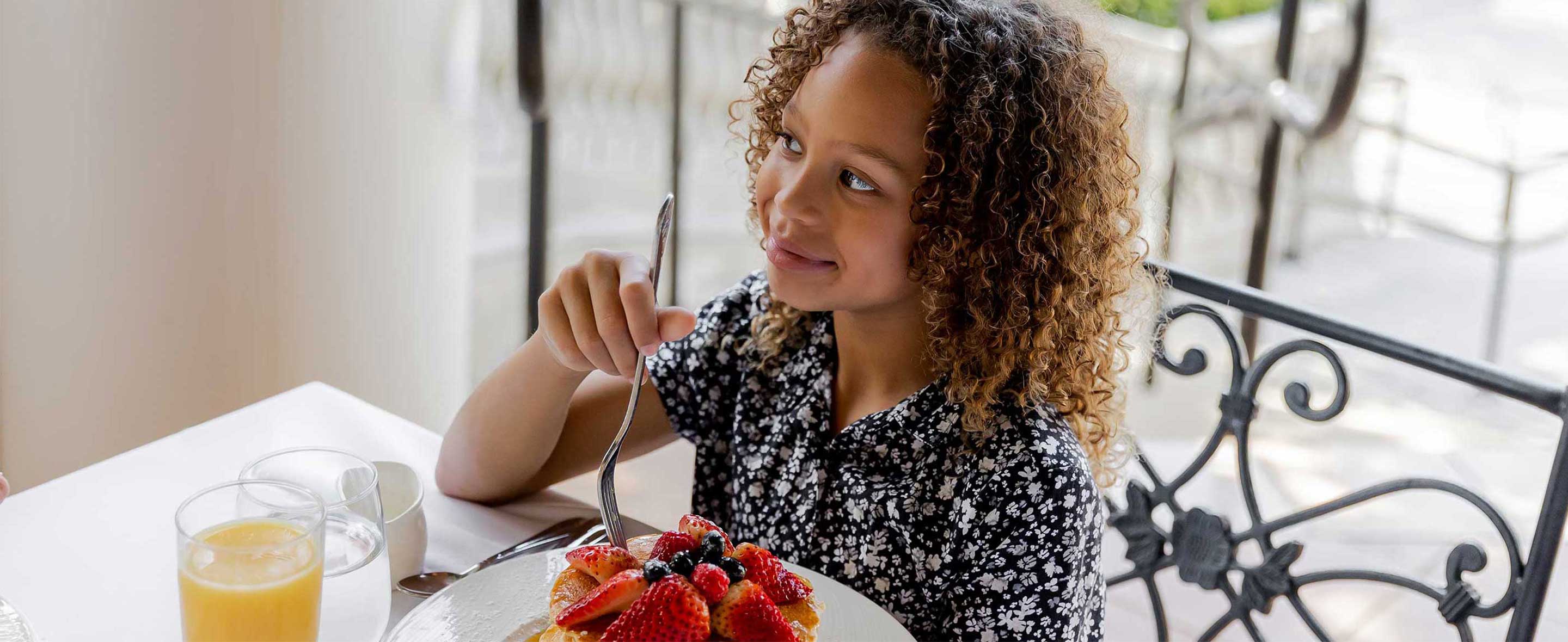 Little girl eating pancakes