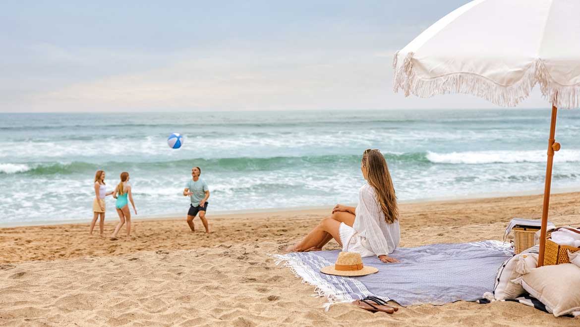 Family playing beach volleyball