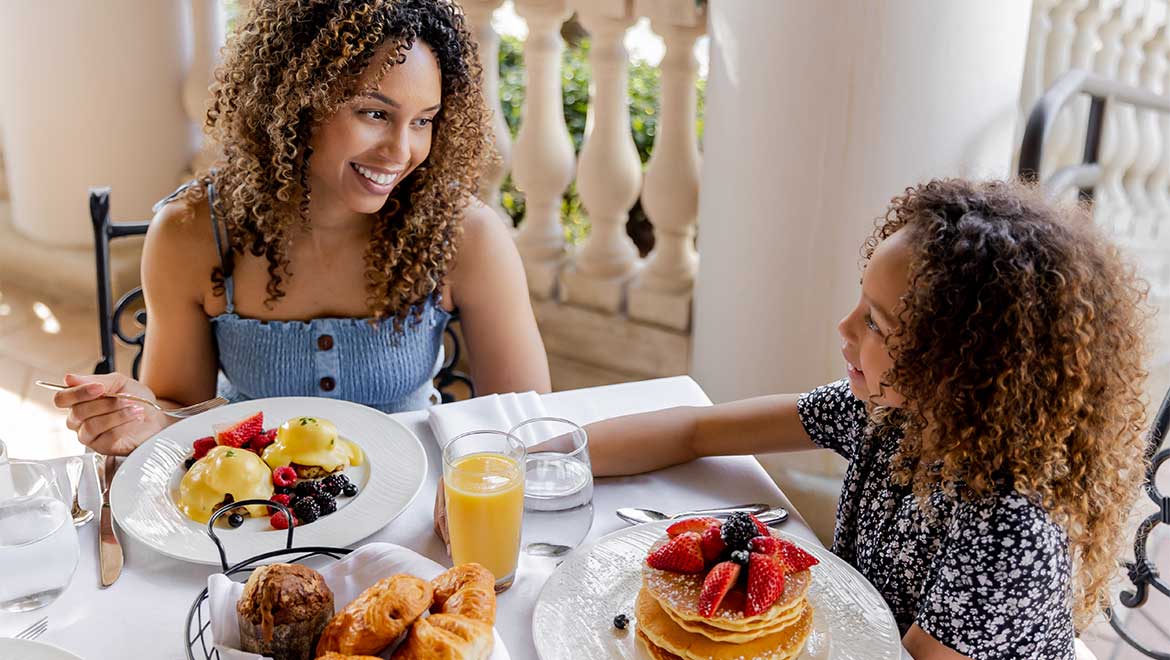 Mom and daughter having breakfast