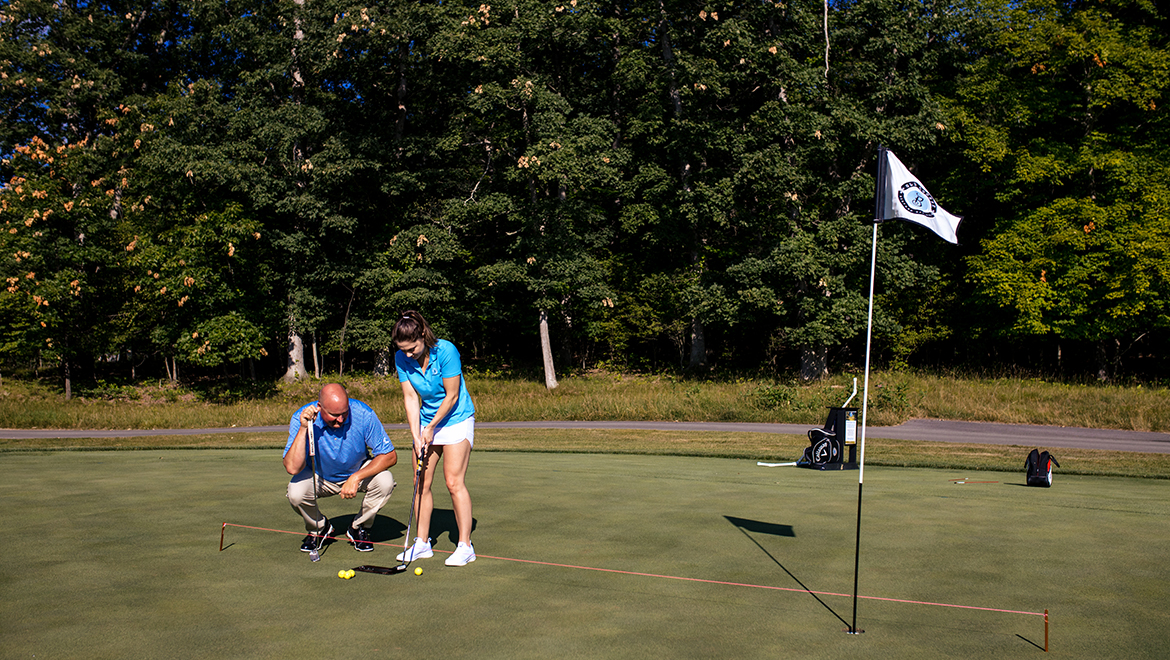 Person receiving golf lesson